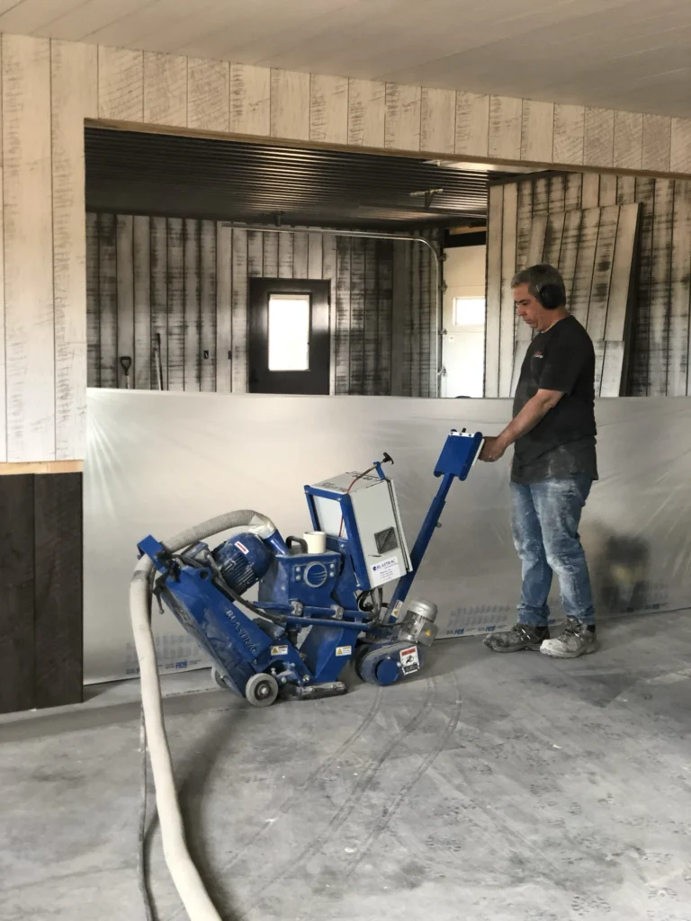 Shot blasting the concrete for prep